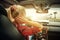 Beutiful blond girl comb her hair with a rearview mirror in car