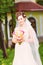 Beutiful bride in white dress holding wedding