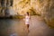 Beutiful latin mexican girl tourist walking on beach with rocks