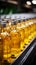 Beverage production line filling glass bottles with refreshing apple and pineapple juice