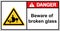 Beware of broken glass. Glass shards dump area. Sign Danger