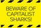 Beware of capitalist sharks warning sign