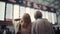Bewildered and Frustrated Senior Couple Looking At Arrival and Departure Board at the Crowded Airport - Generative AI
