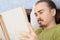 Bewildered man reading book