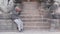 BHAKTAPUR, KATHMANDU, NEPAL - 18 October 2018 Poor man on stone steps. Aged poor man sitting on empty stone steps of