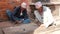 BHAKTAPUR, KATHMANDU, NEPAL - 18 October 2018 Senior men playing intellectual game on sidewalk. Aged men sitting on