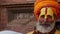 BHAKTAPUR, KATHMANDU, NEPAL - 18 October 2018 Senior Sadhu man with face painted. Elderly Sadhu man wearing colorful