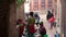 BHAKTAPUR, NEPAL - 13 OCTOBER 2018 People washing near temple wall. View of women washing hair and clothes with water