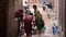 BHAKTAPUR, NEPAL - 13 OCTOBER 2018 People washing near temple wall. View of women washing hair and clothes with water