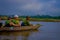 BHAKTAPUR, NEPAL - NOVEMBER 04, 2017: Unidentified people canoeing safari on wooden boats Pirogues on the Rapti river