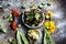 Bhareli bhinid or fried okra in a glass plate on wooden surface along with its entire raw ingredients and spices.