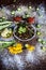 Bhareli bhinid or fried okra in a glass plate on wooden surface along with its entire raw ingredients and spices.