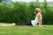 Bhujangasana cobra pose by woman on green grass in the park