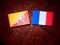 Bhutan flag with French flag on a tree stump isolated