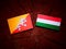 Bhutan flag with Hungarian flag on a tree stump isolated