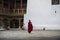 Bhutanese Buddhist monk walks alone inside of Dzong , Bhutan