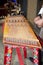 Bhutanese musician is playing a yangqin, Bhutan