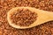 Bhutanese Red Rice seed. Grains in wooden spoon. Close up.