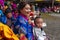 Bhutanese rich dressed mother and son enjoy the cham dance . Bumthang, central Bhutan.