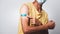 Bi-colored Asian man showing vaccinated arm with adhesive patch after getting Covid-19 vaccine injection