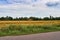 Biale, Poland - August 04, 2017: Harvester is working on the field. Stacks of straw and hay on the wheat field in Poland, late