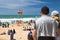 Biarritz, France - May 20, 2017: back view of people on crowded sandy beach watching and taking photos of surfers isa world surfin