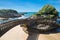 Biarritz, France - May 20, 2017: people walking on footbridge leading to cliff island over sandy beach in touristic destination su