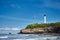 Biarritz, France. Sand beach Miramar Plage overlooking the white lighthouse - Phare de Biarritz on the Pointe Saint-Martin