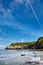 Biarritz, France. Sand beach Miramar Plage overlooking the white lighthouse - Phare de Biarritz on the Pointe Saint-Martin.  Bay