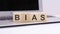 Bias - wooden cubes with letters on a laptop keyboard