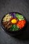 Bibimbap Korean Style rice dish. Bowl of warm white rice topped with Beef Bulgogi, SautÃ©ed and seasoned vegetables