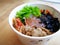 Bibimbap, traditional Korean dish in a take away box, rice with vegetables and beef.