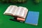 Bible Alkitab Open Blue Notebook and Stationery on Green Background