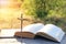 The Bible on the background of the cross and life-giving light