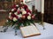 The Bible in the Church in front of a bouquet of flowers