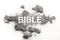 Bible word written in grey ash, dust