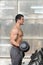 Biceps Exercise With Dumbbell in a Gym