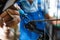 Bicycle assembly in workshop, man oiling the chain