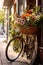a bicycle with a basket of fresh flowers on a sunny day