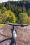 Bicycle by a cliff and a forest with autumn colors