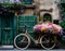 A bicycle covered in flowers outside a building