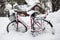 Bicycle covered with snow.