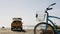 Bicycle cruiser bike by ocean beach, California coast USA. Summer cycle, lifeguard car pick up truck