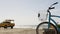 Bicycle cruiser bike by ocean beach, California coast USA. Summer cycle, lifeguard car pick up truck