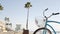 Bicycle cruiser bike by ocean beach, California coast USA. Summer cycle, lifeguard hut and palm tree