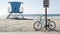 Bicycle cruiser bike by ocean beach, California coast USA. Summer cycle, lifeguard tower, road sign