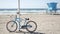 Bicycle cruiser bike by ocean beach California coast USA. Summer sea shore. Cycle by lifeguard tower