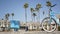 Bicycle cruiser bike by ocean beach, California coast USA. Summertime cycle, houses and palm trees.