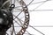 Bicycle disk brakes close up, metal disc attached to bike wheel, effective mountain bicycle brakes