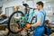 Bicycle factory, worker holds mountain bike